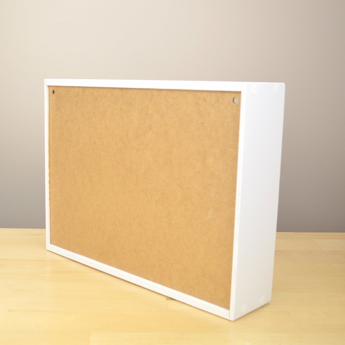 Back view of an ink pad organizer showing the holes for wall mounting. 