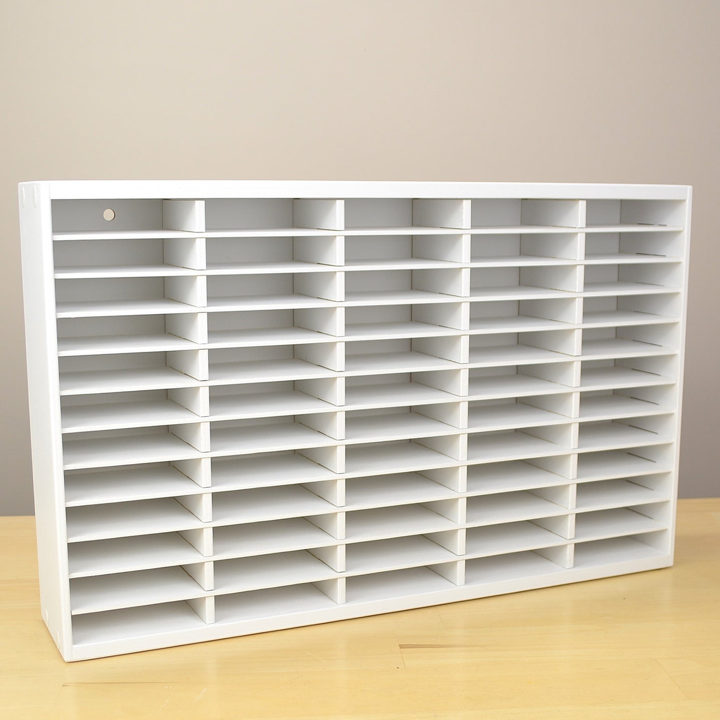 Angle view of a white storage rack made to hold Stampin Up ink pads. 