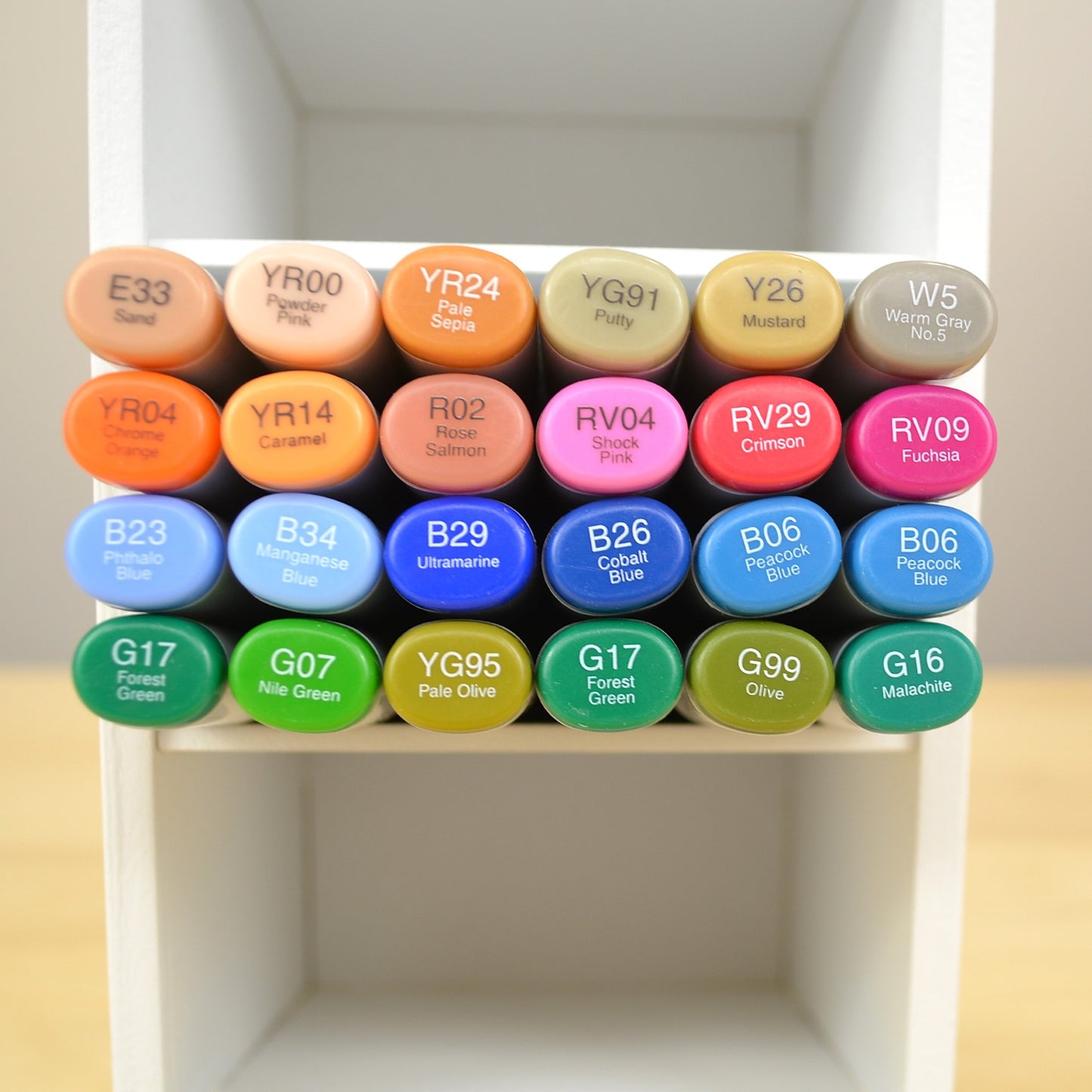 Closeup of an individual cubby of a marker organizer holding 24 Copics. 