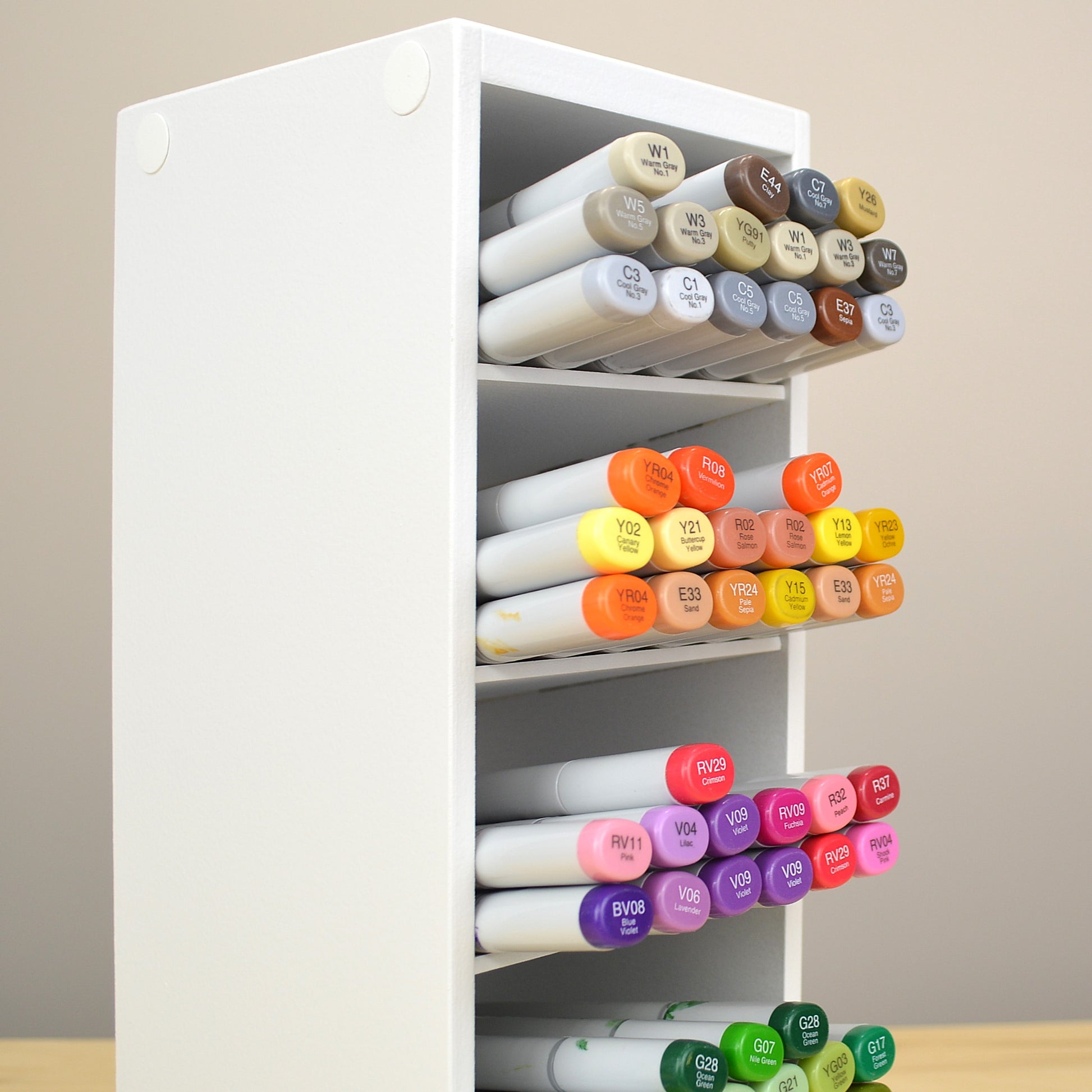 Side view showing Copic markers in a storage organizer that's painted white. 