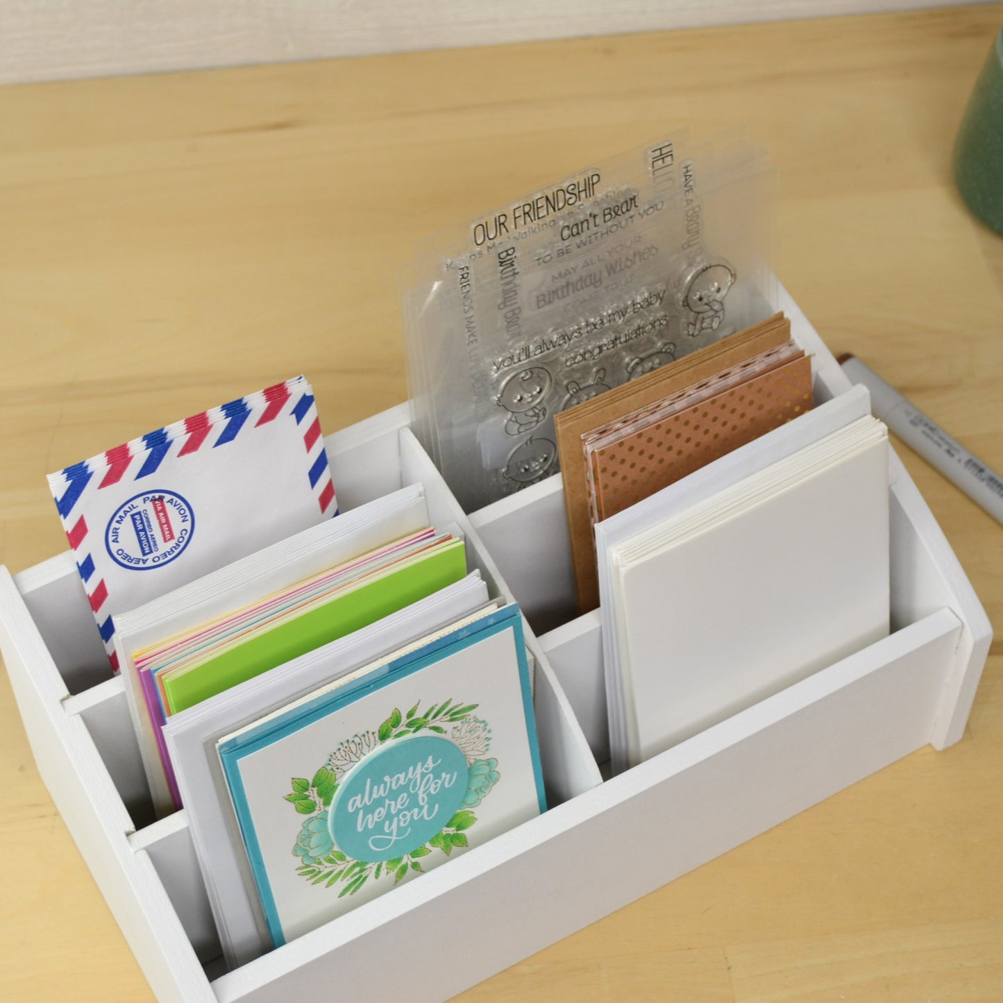 top view of a card caddy showing the width of the cubbies with cards inside