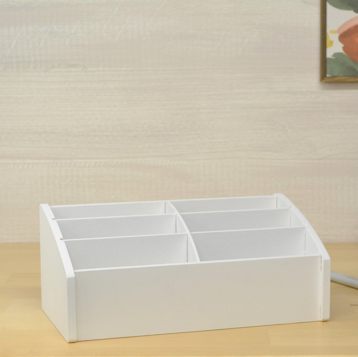 an empty white desktop organizer that is made to hold greeting cards sitting on a wooden table