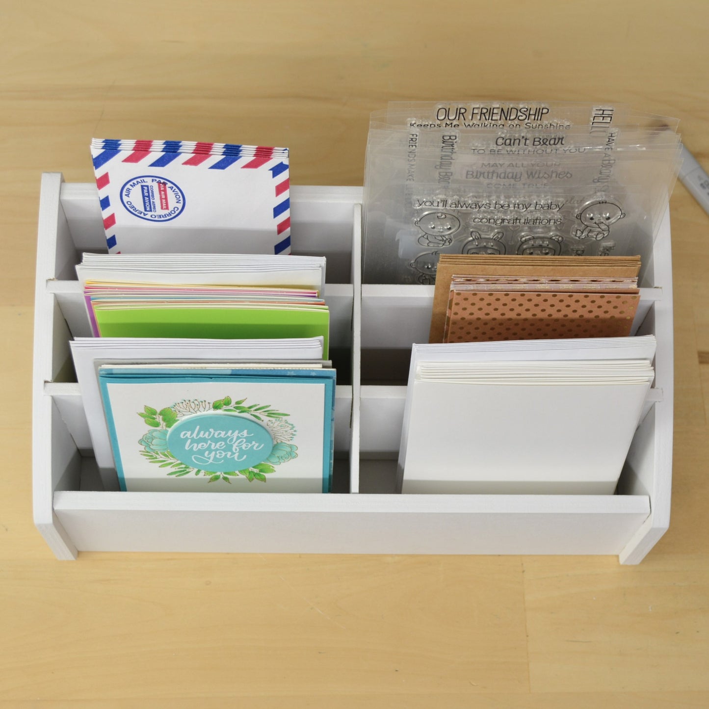 top view of handmade greeting cards in a six section desktop caddy