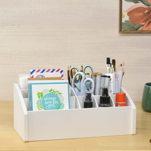 wooden desk caddy holding greeting cards and markers, pens, and scissors