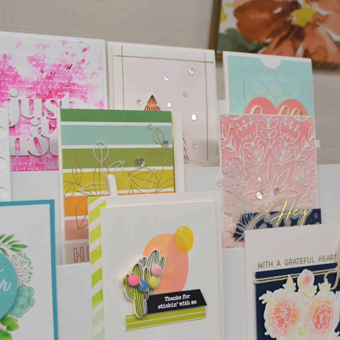 closeup angle view of beautiful greeting cards displayed on a tiered shelf stand in a craft room 