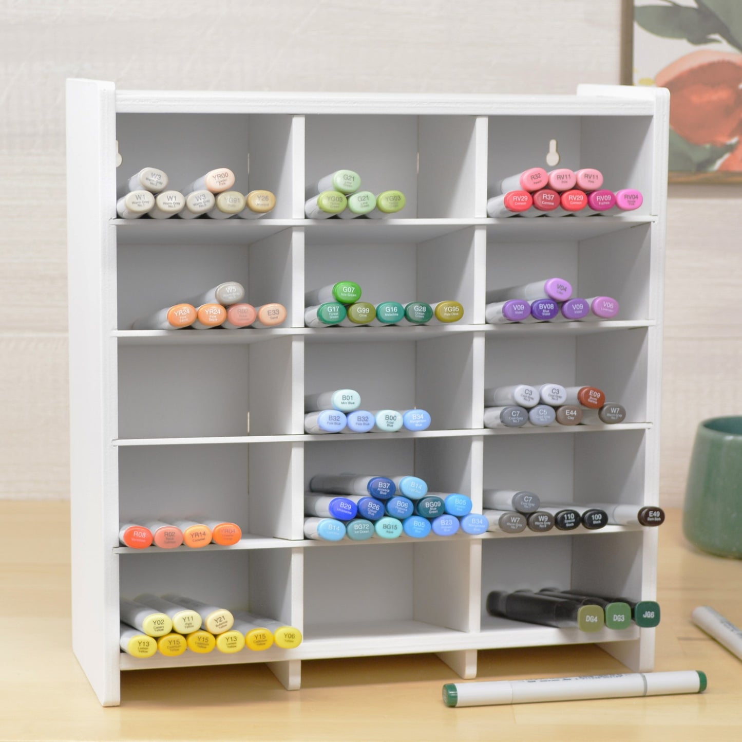 large craft marker organizer with fifteen cubbies, painted white and full of copics