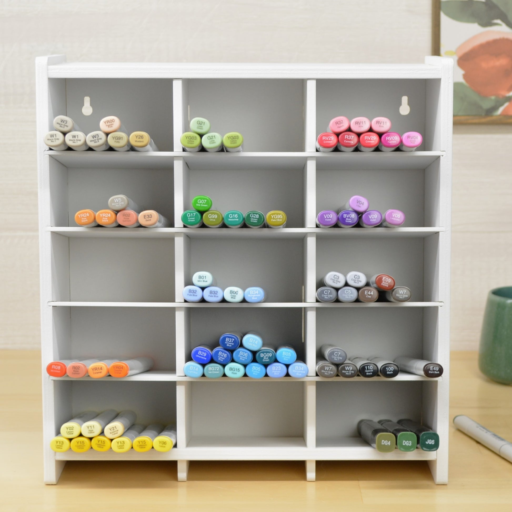 large craft marker holder with multiple cubbies on a desktop 