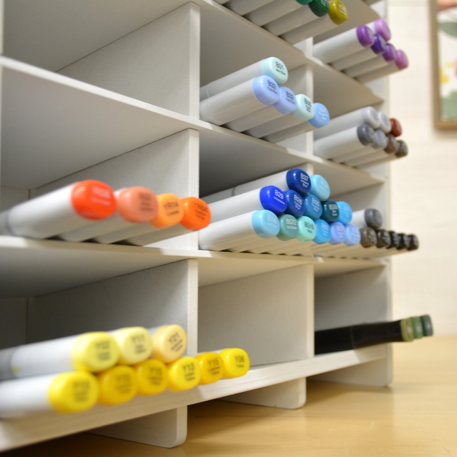 closeup view of marker organizer cubbies showing the slanted angle of the shelves