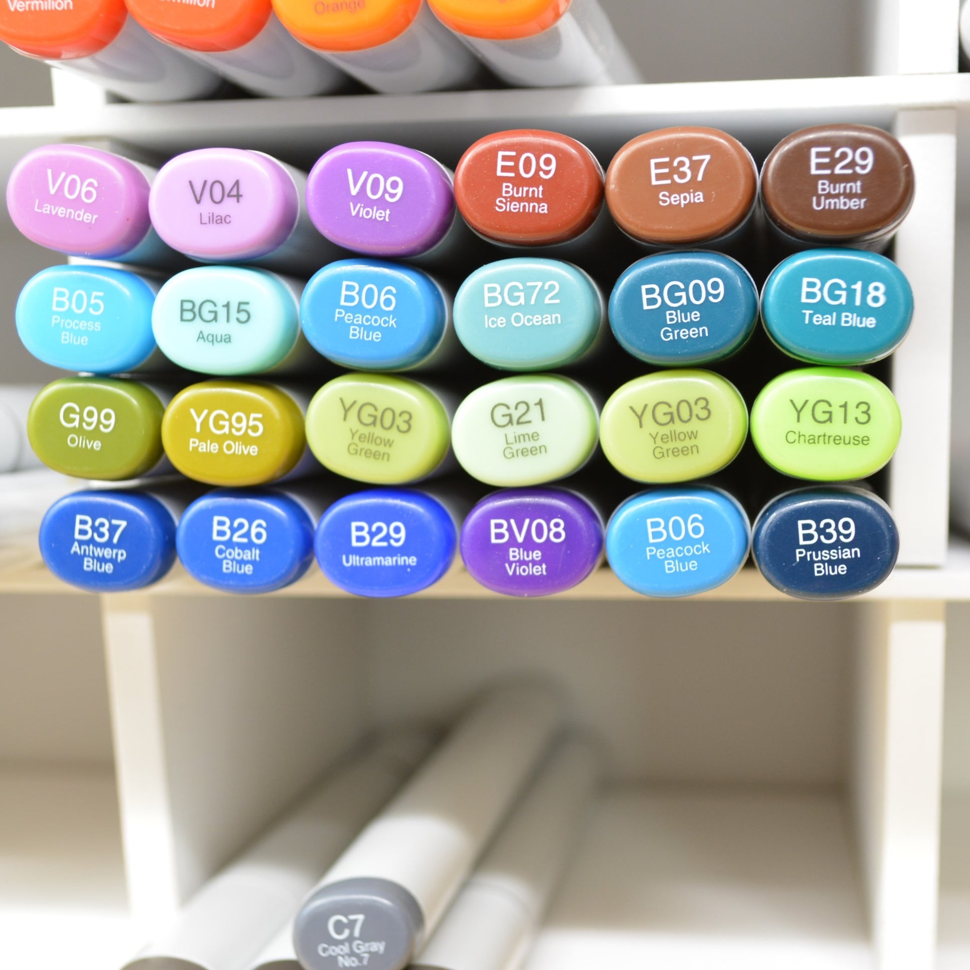 closeup of one cubby holding twenty four colorful copic markers