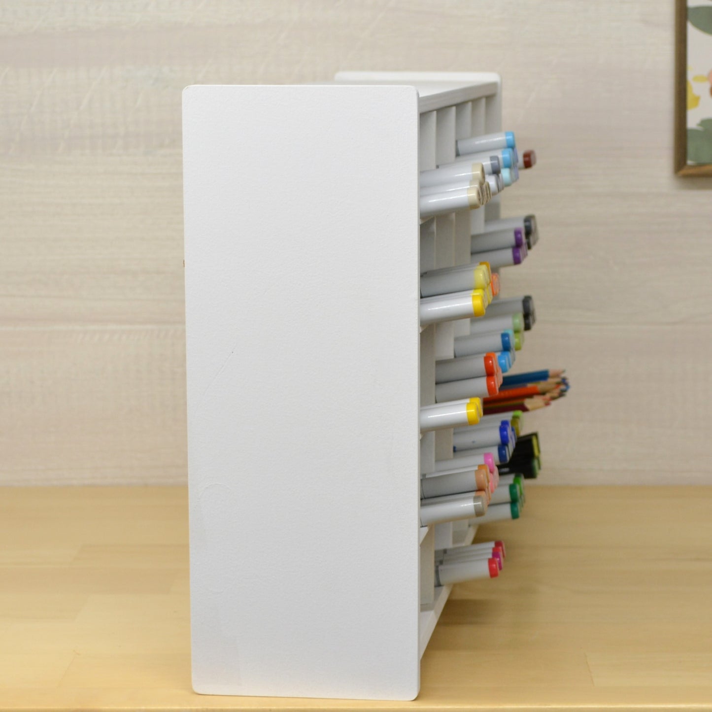 side view of a huge marker organizer with markers on slanted shelves and sticking out about an inch